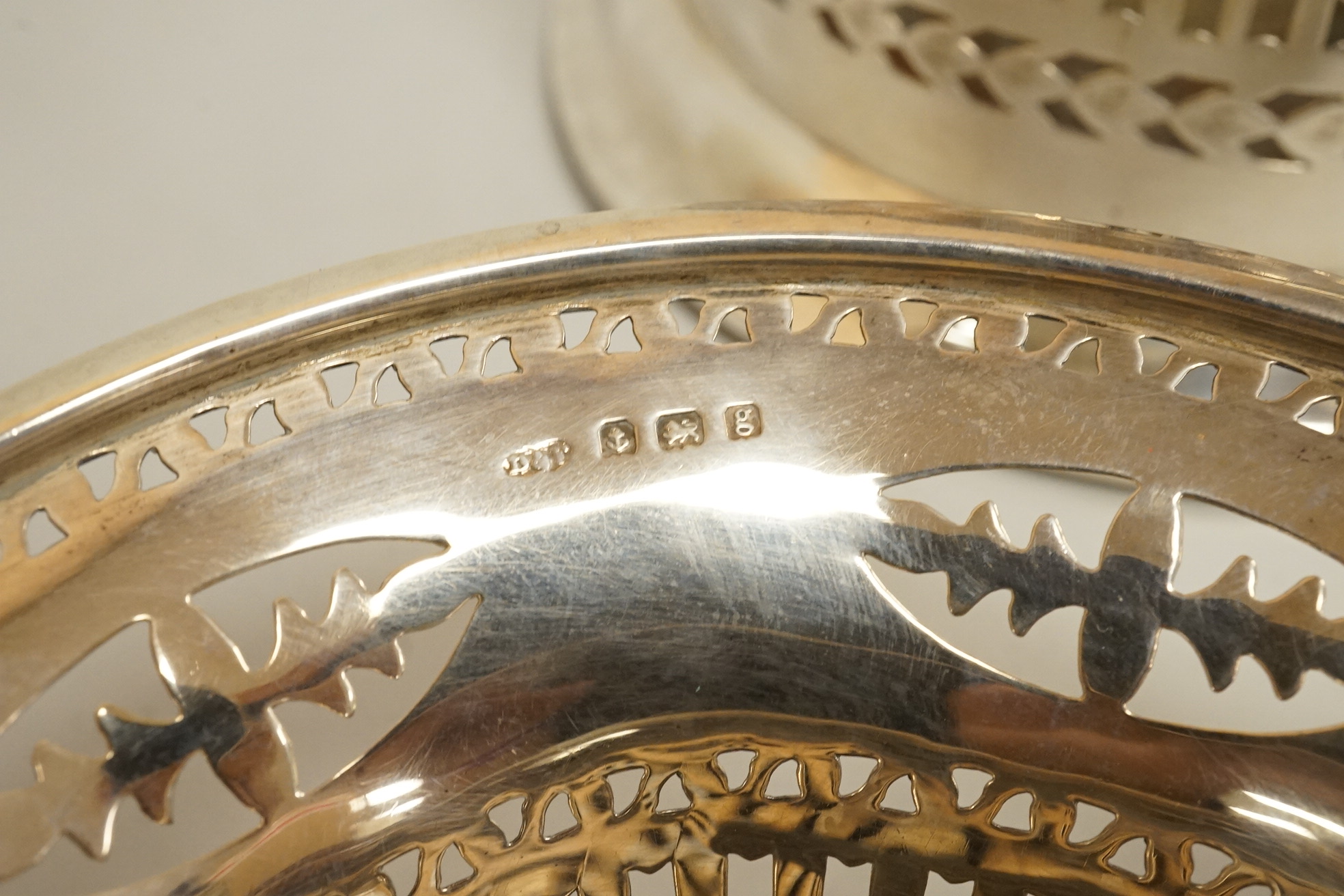 Two pairs of early 20th century silver bonbon dishes, including smallest by Mappin & Webb, Birmingham, 1913, height 6cm, together with an Edwardian silver butter shell and a pair of Edwardian silver mounted bottle coaste